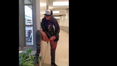 Pantyless MILF slaps pussy in public mall